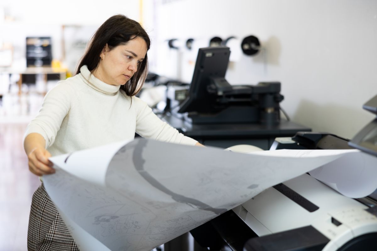 used-printers-woman-using-copier Woman using a used printer in office