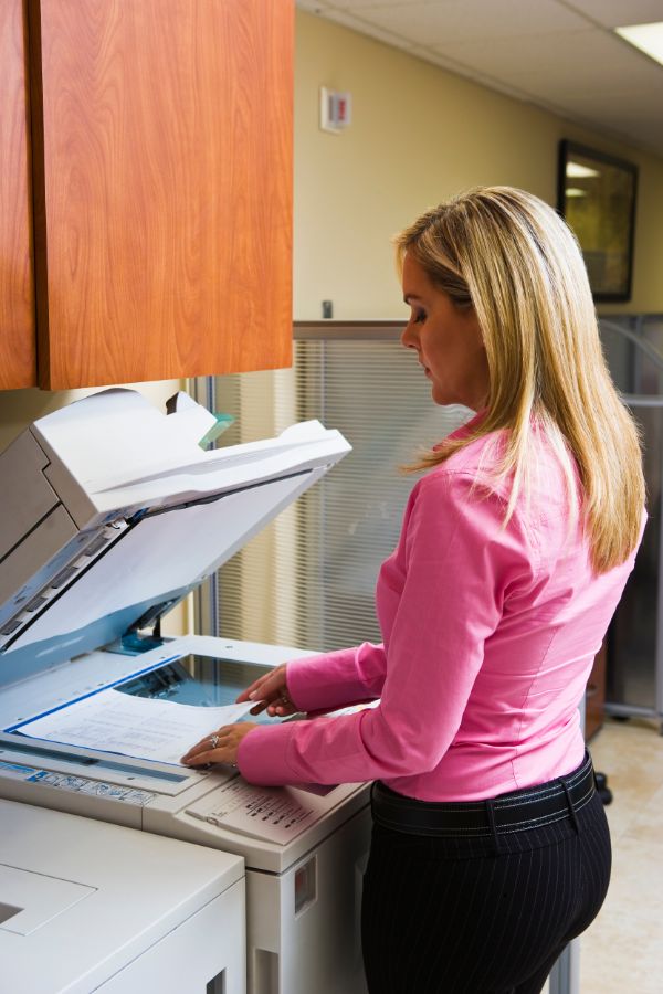 Woman using a mono laser printer